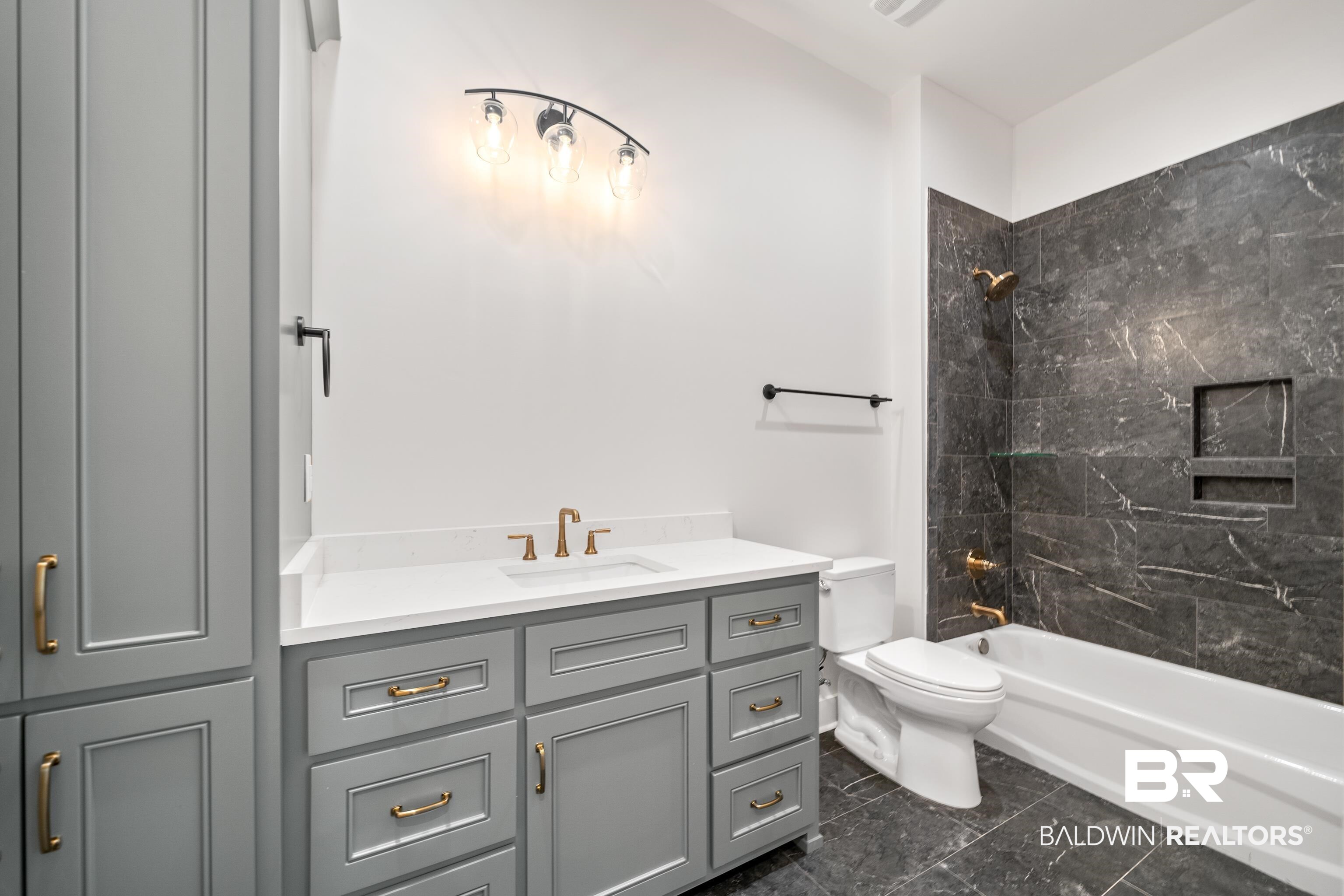 12453 County Road 1 Fairhope, AL 36532 - Photo 20 of 33 Full bathroom featuring vanity, toilet, and tiled shower / bath