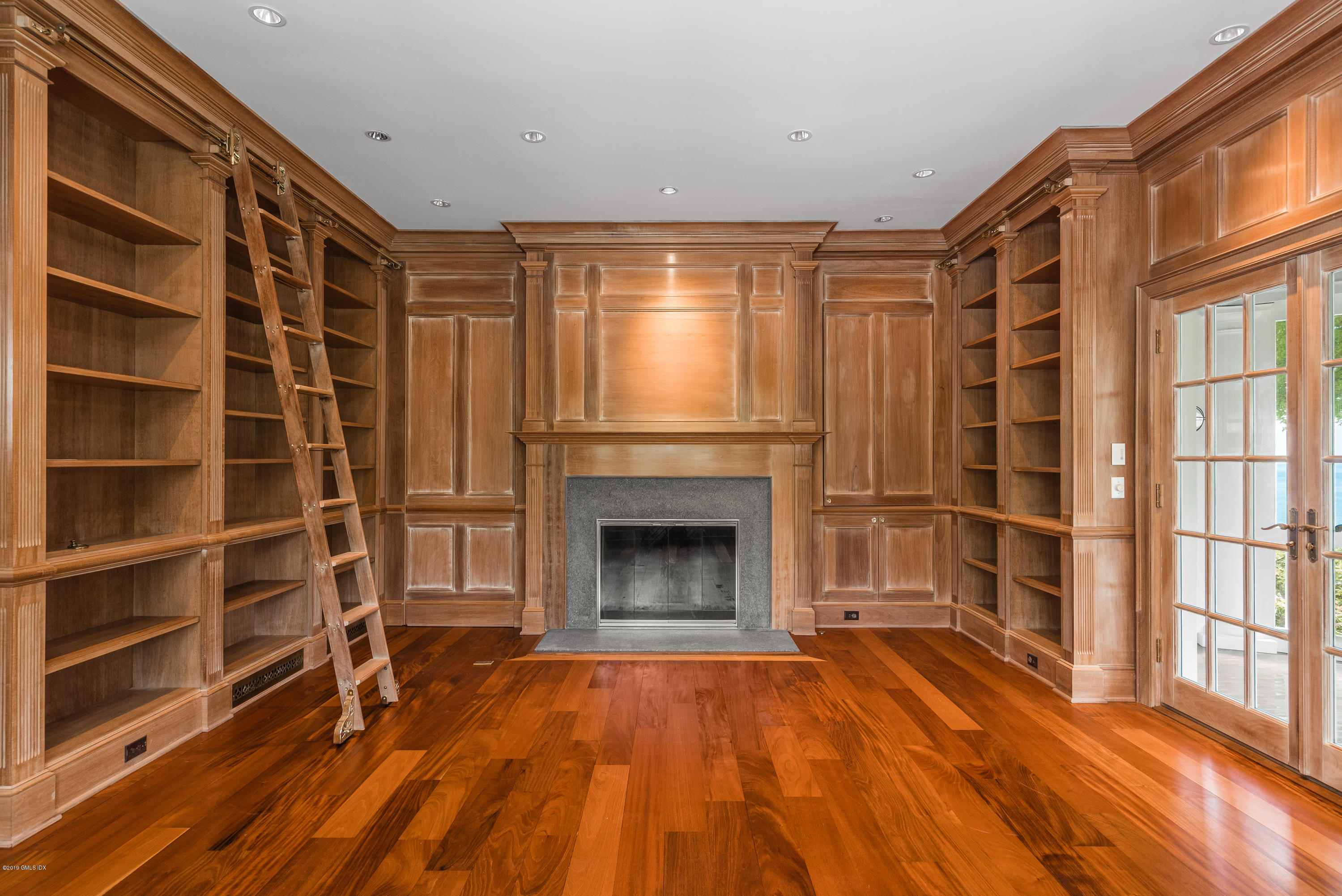 35 Byram Shore Road Greenwich, CT 06830 - Photo 11 of 32 a view of an empty room with a fireplace and a window