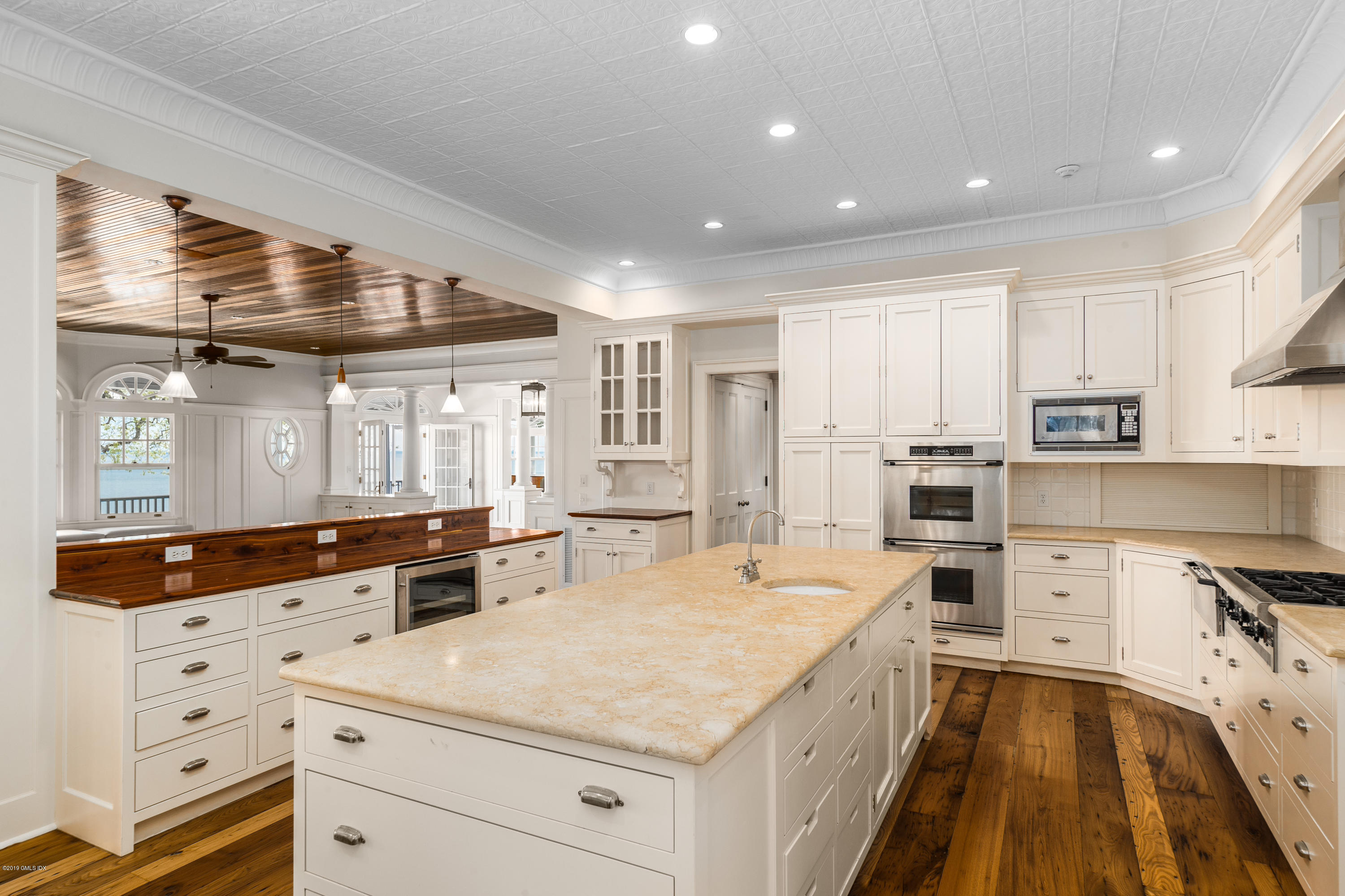 35 Byram Shore Road Greenwich, CT 06830 - Photo 13 of 32 a large white kitchen with a stove a sink a refrigerator and white cabinets