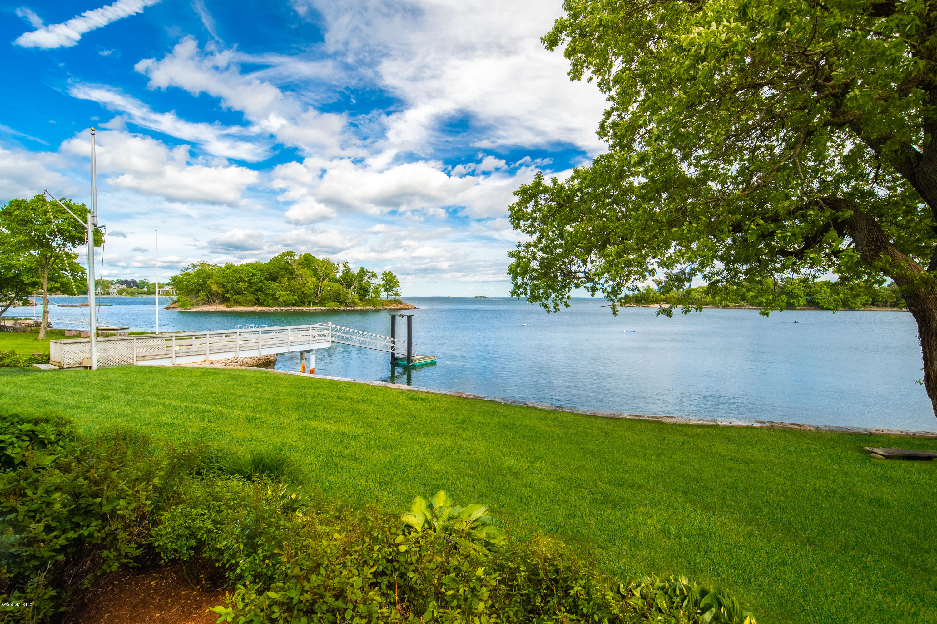 35 Byram Shore Road Greenwich, CT 06830 - Photo 17 of 32 a view of yard with swimming pool and green space