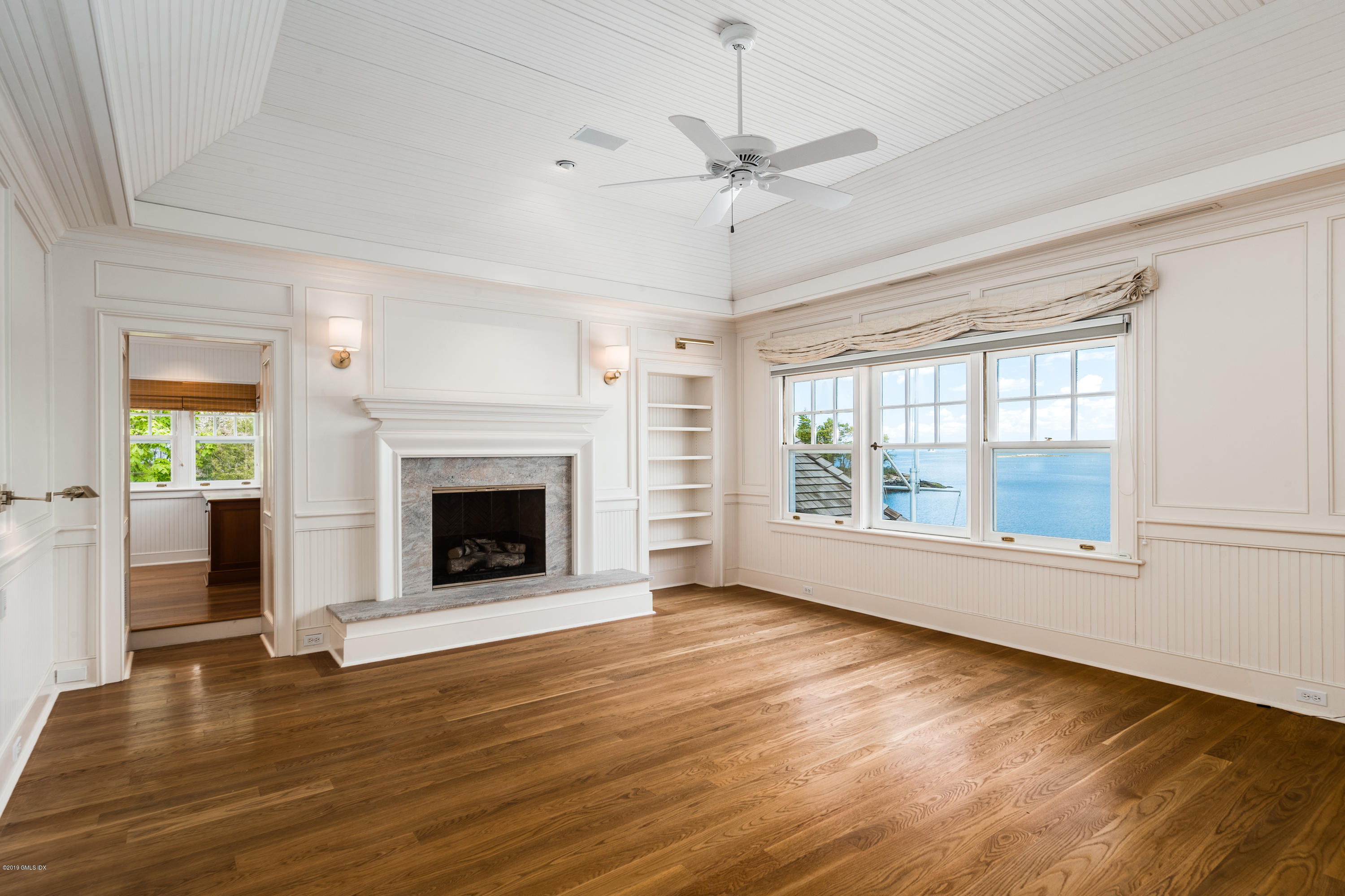 35 Byram Shore Road Greenwich, CT 06830 - Photo 19 of 32 a view of an empty room with wooden floor fireplace and a window