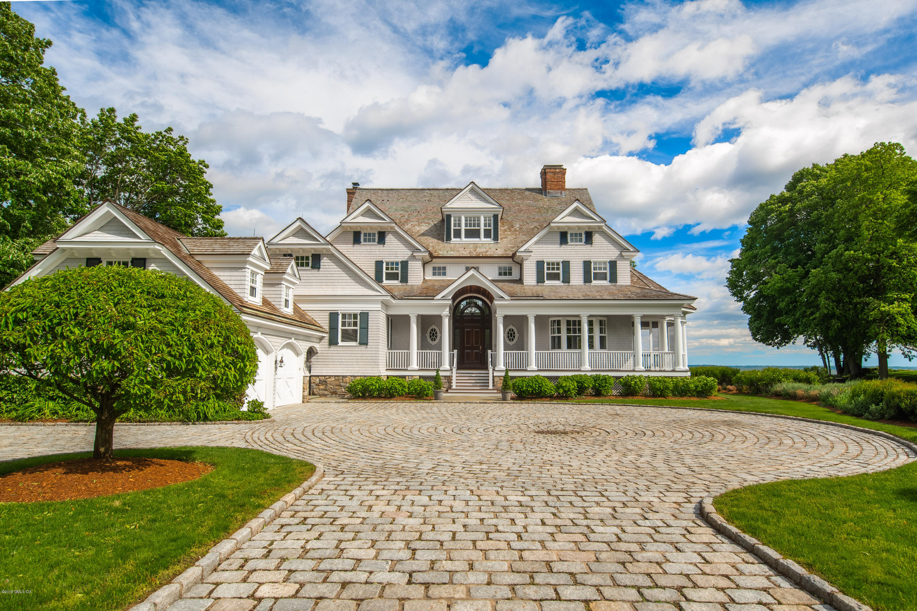 35 Byram Shore Road Greenwich, CT 06830 - Photo 26 of 32 a front view of a house with a garden