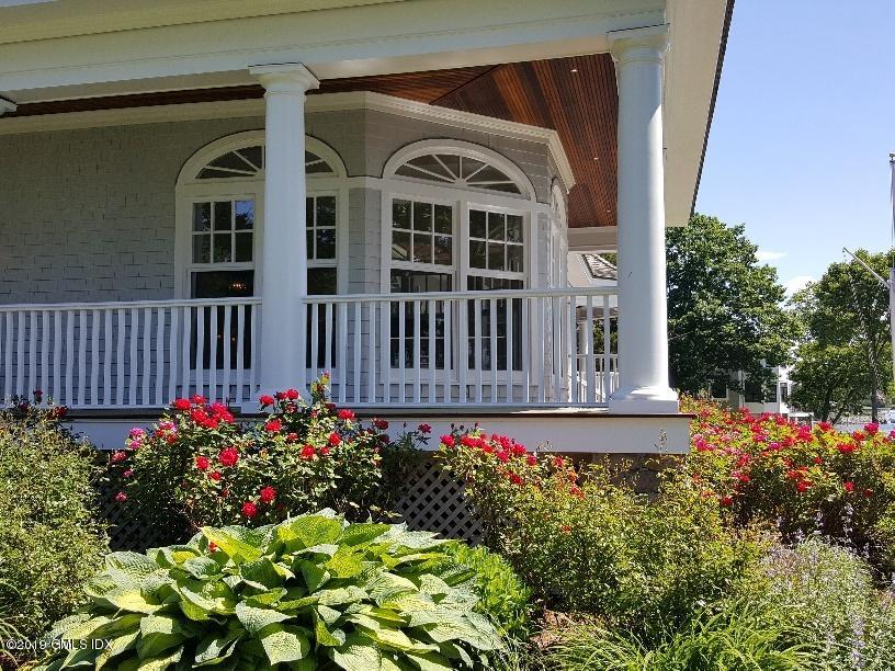 35 Byram Shore Road Greenwich, CT 06830 - Photo 27 of 32 a front view of a house with a yard