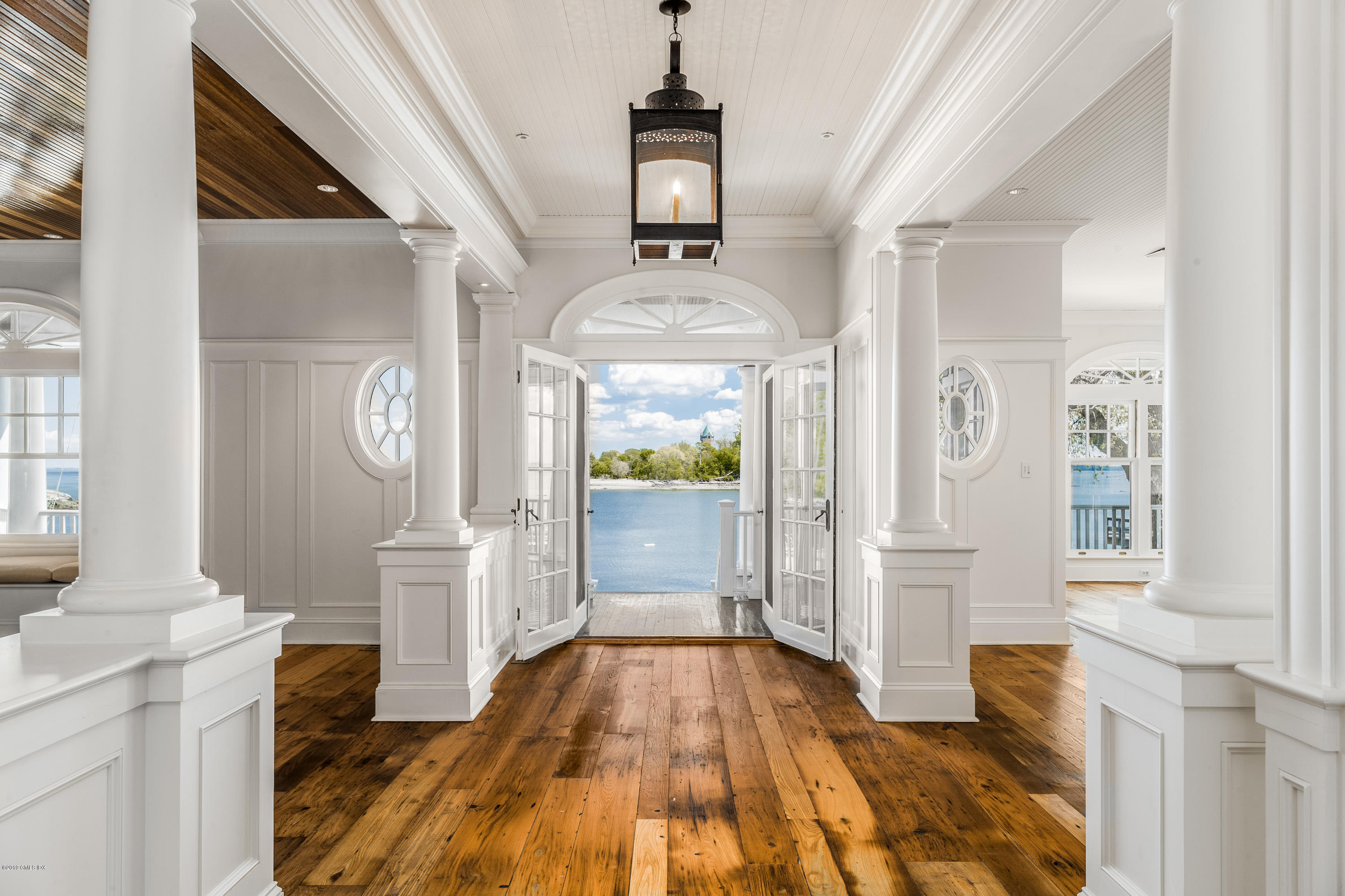 35 Byram Shore Road Greenwich, CT 06830 - Photo 7 of 32 a view of a hallway with wooden floor and front door