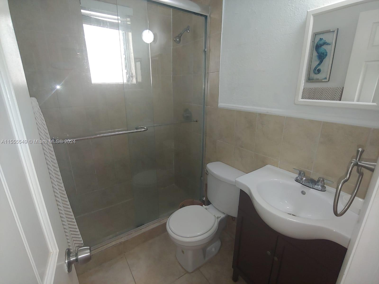 7928 Harding Avenue, Unit 8 Miami Beach, FL 33141 - Photo 20 of 30 a bathroom with a sink a toilet and shower