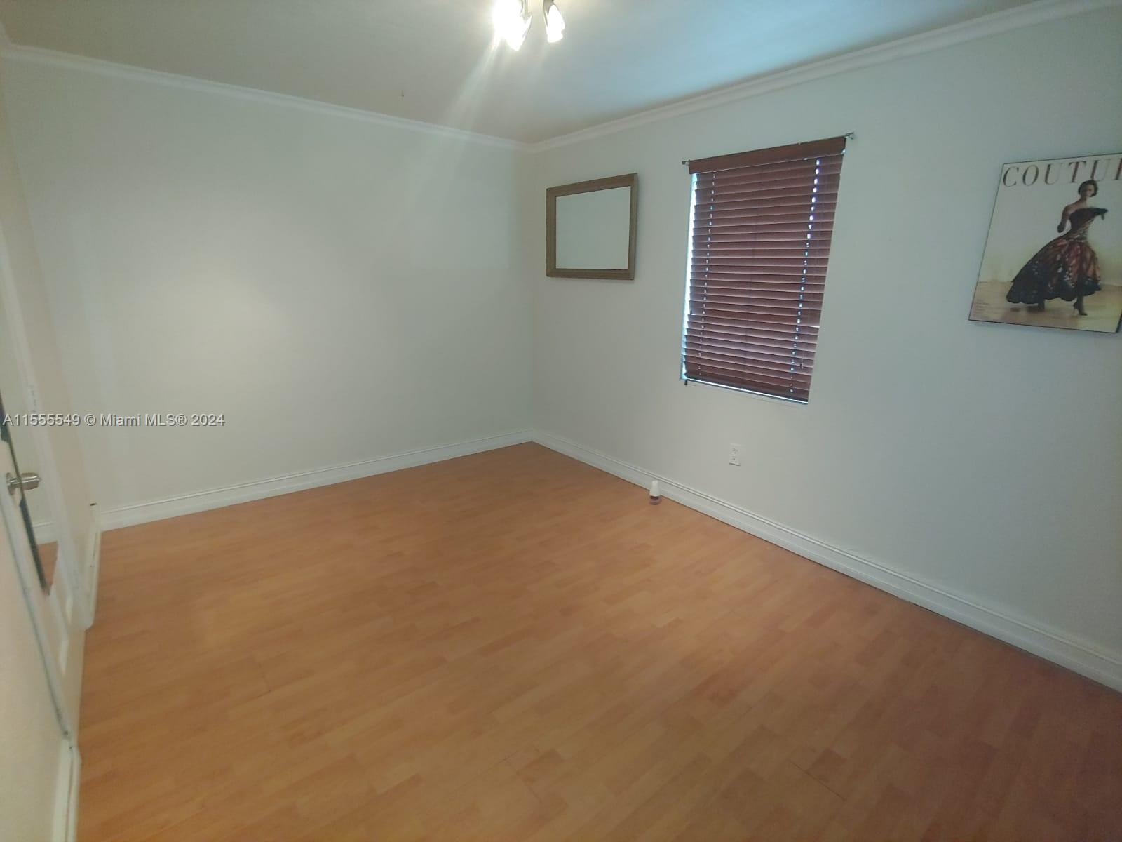 7928 Harding Avenue, Unit 8 Miami Beach, FL 33141 - Photo 22 of 30 an empty room with windows