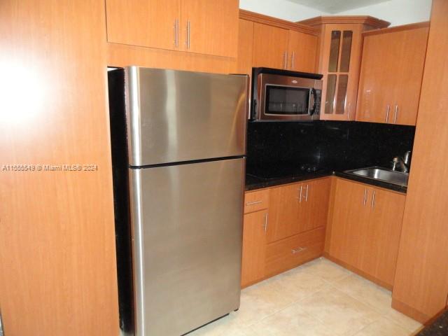 7928 Harding Avenue, Unit 8 Miami Beach, FL 33141 - Photo 24 of 30 a view of a refrigerator in kitchen and an empty room