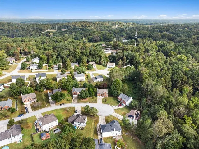 an aerial view of residential houses with outdoor space