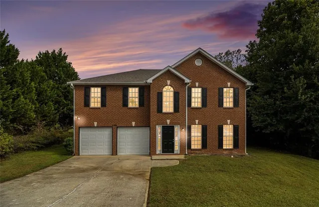 a front view of a house with a yard and garage