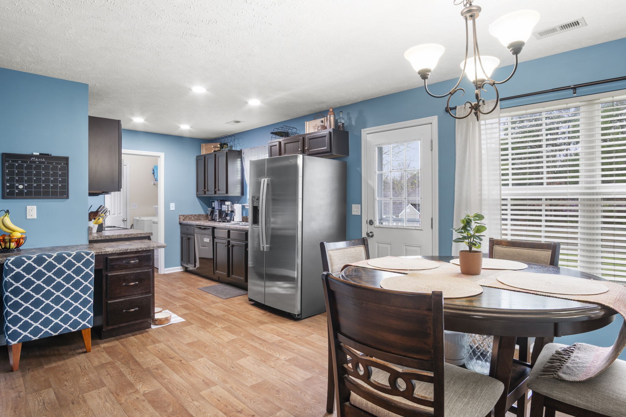 3306 Barretts Ridge Drive Murfreesboro, TN 37130 - Photo 12 of 24 a kitchen with granite countertop a table chairs stove and refrigerator