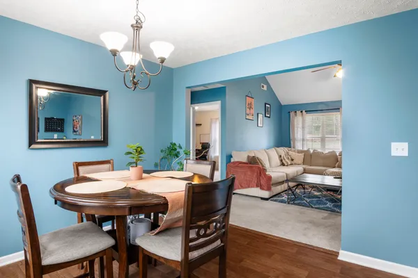 a view of a dining room with furniture and wooden floor