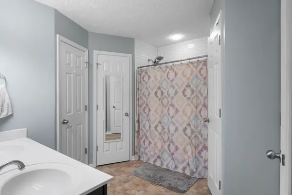 a bathroom with a sink and a shower