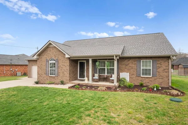 a front view of house with yard and green space