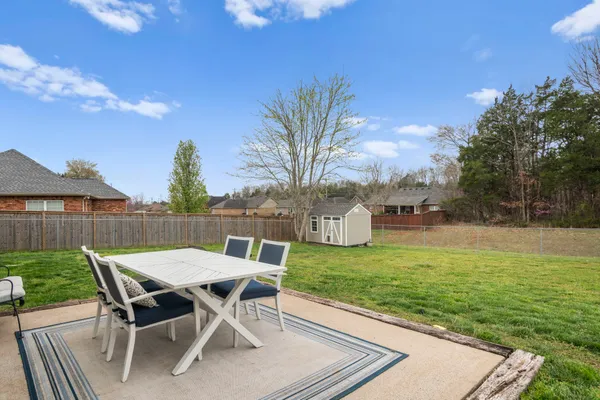 a view of a backyard with a garden and seating area