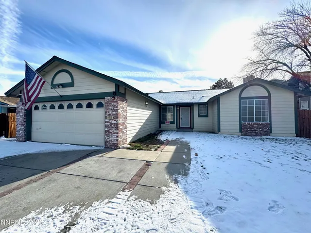 a front view of a house with a garden and garage
