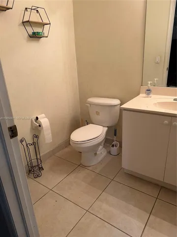 a bathroom with a sink toilet and mirror