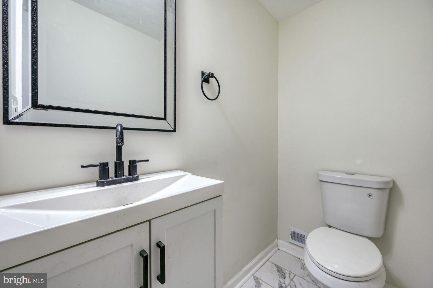 402 South Eaton Street Baltimore, MD 21224 - Photo 12 of 23 Sleek modern bathroom with elegant finishes.