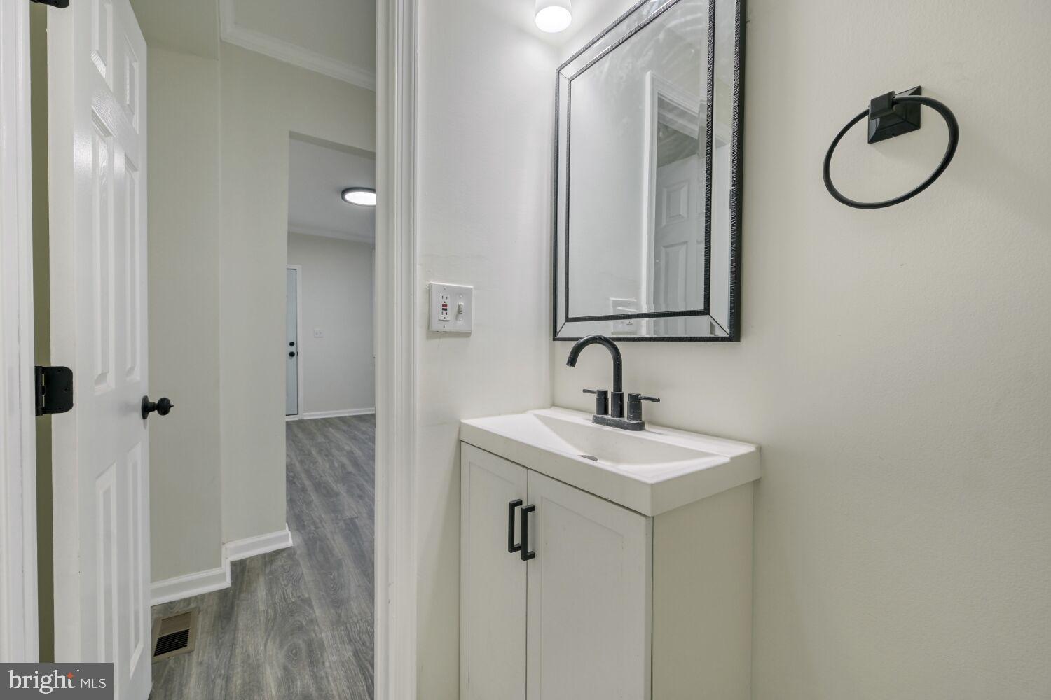 402 South Eaton Street Baltimore, MD 21224 - Photo 13 of 23 Sleek modern half-bath with stylish fixtures.
