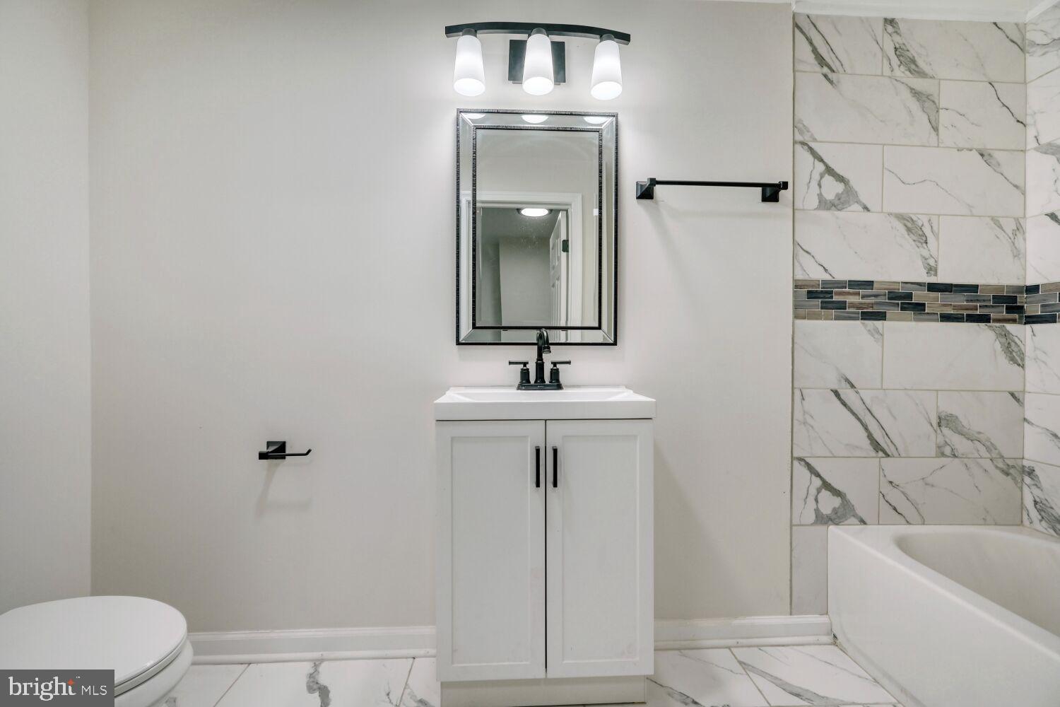 402 South Eaton Street Baltimore, MD 21224 - Photo 15 of 23 Modern elegance in a serene bathroom retreat.