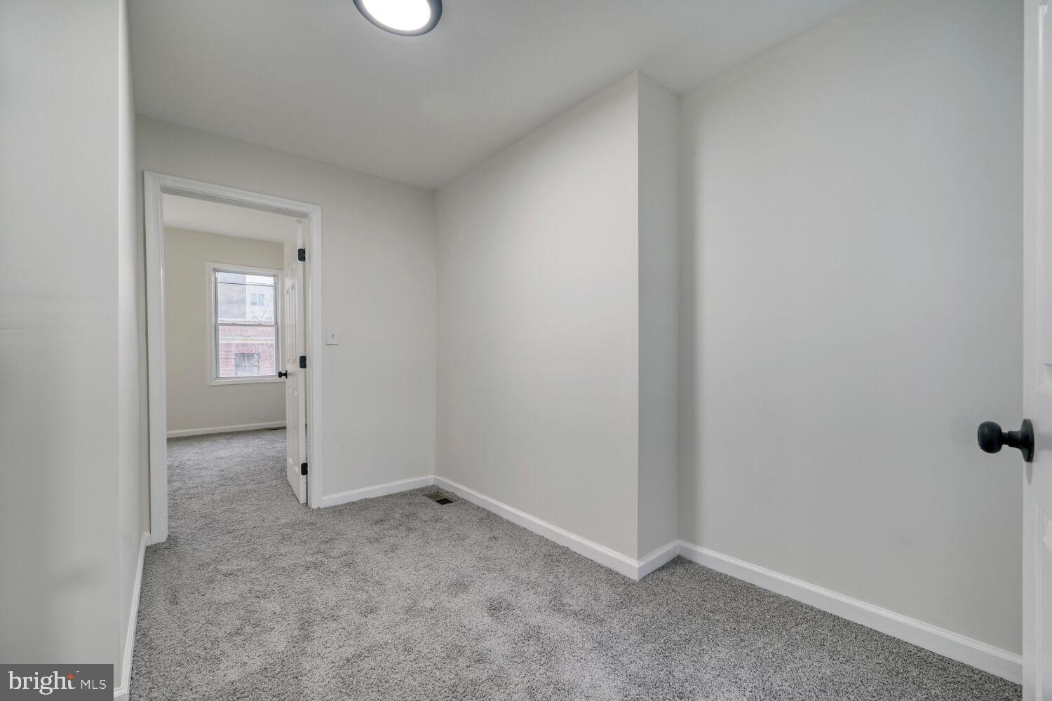 402 South Eaton Street Baltimore, MD 21224 - Photo 17 of 23 Bright and inviting hallway with soft carpet.