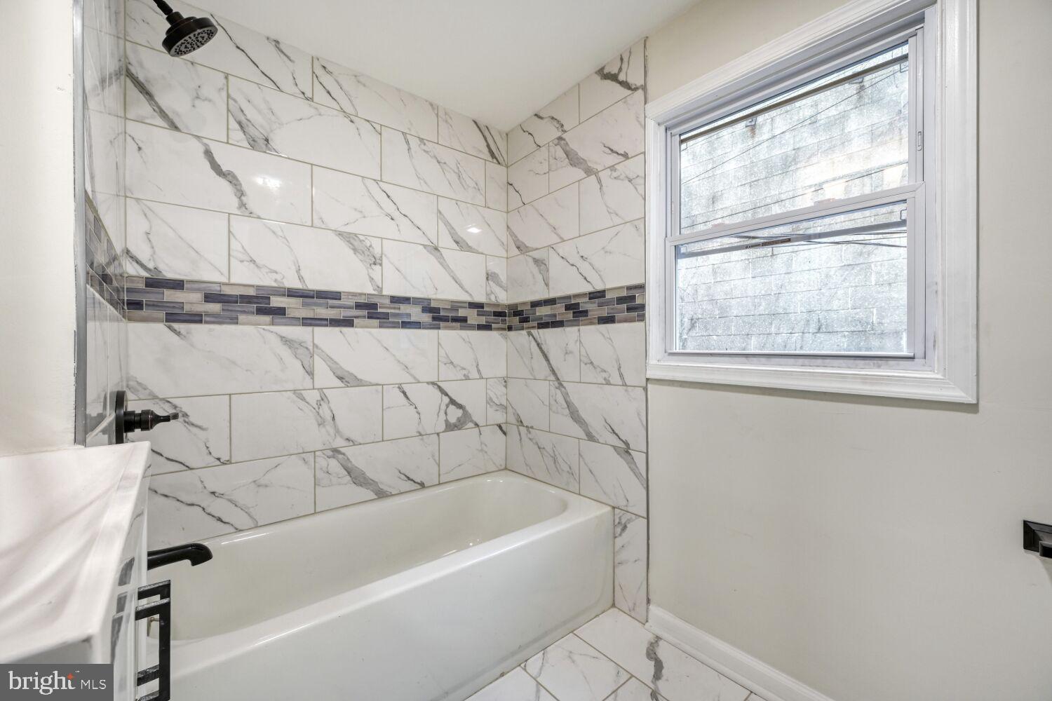 402 South Eaton Street Baltimore, MD 21224 - Photo 21 of 23 Elegant marble bath with modern accents.