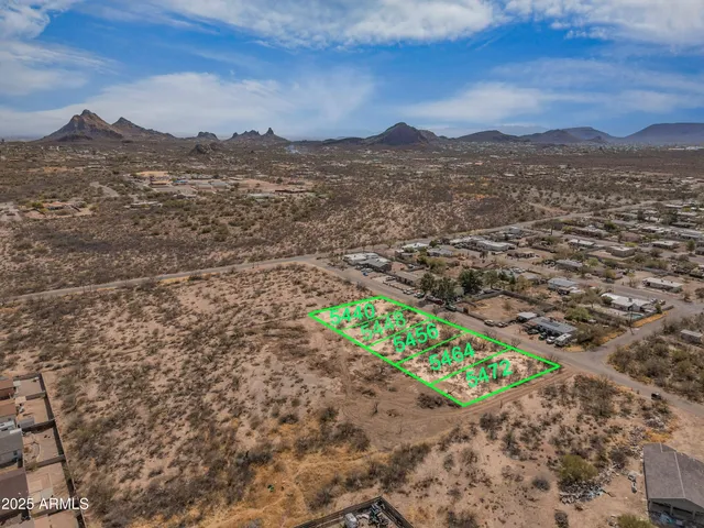 a view of a dry yard with mountains in the background