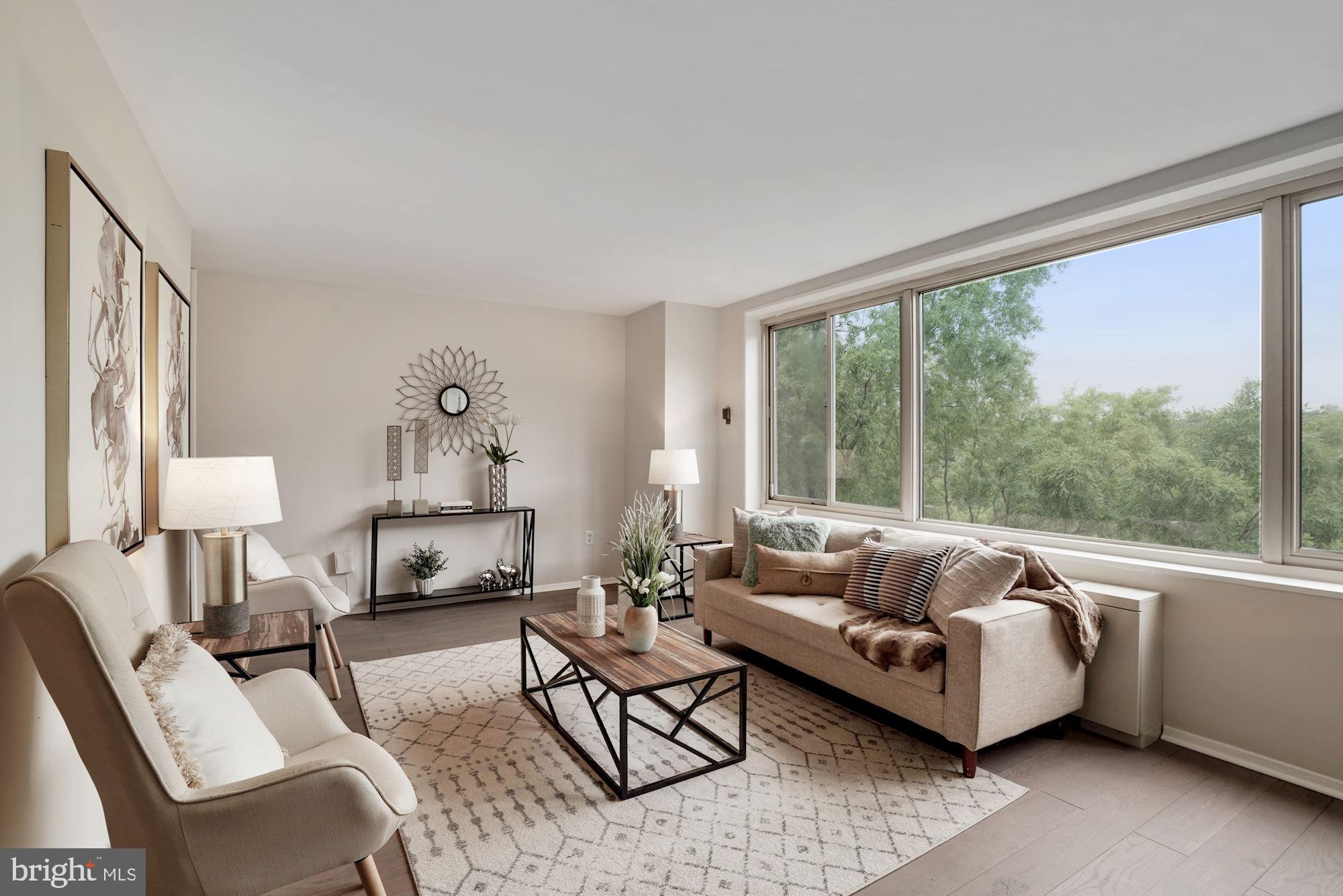 4000 Tunlaw Road Northwest, Unit 1123 Washington, DC 20007 - Photo 1 of 31 a living room with furniture and a large window