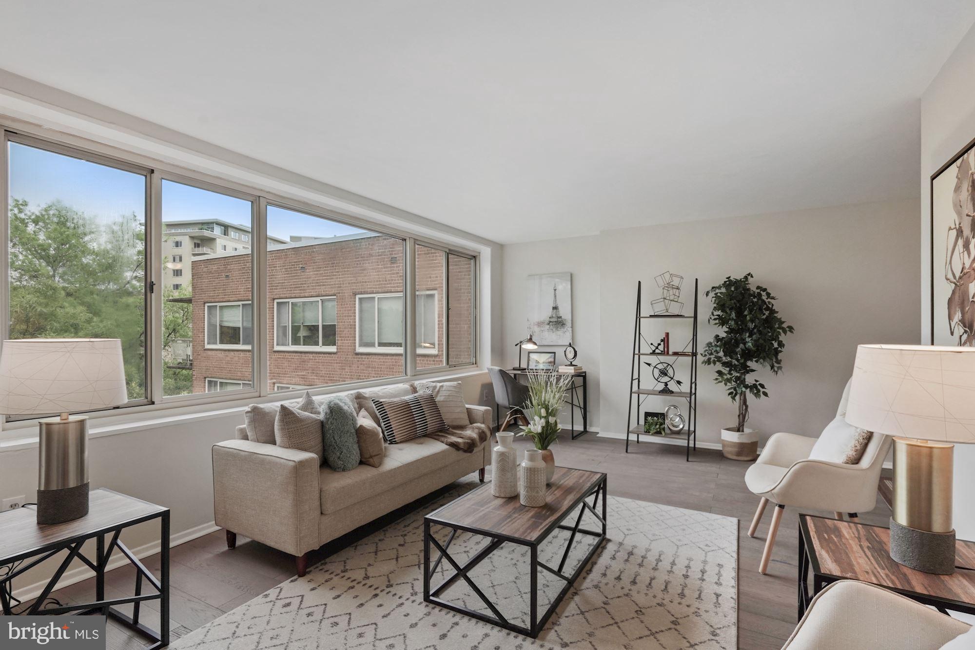 4000 Tunlaw Road Northwest, Unit 1123 Washington, DC 20007 - Photo 2 of 31 a living room with furniture and a large window