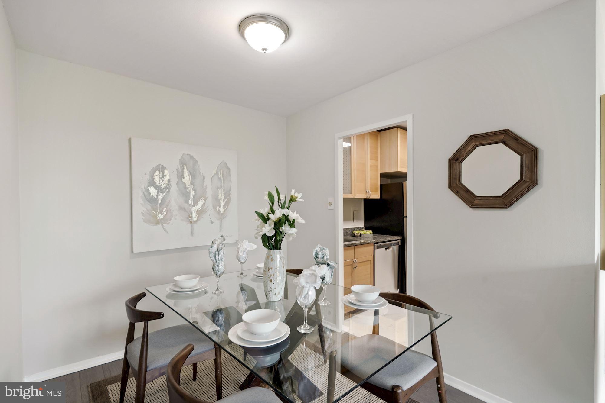 4000 Tunlaw Road Northwest, Unit 1123 Washington, DC 20007 - Photo 11 of 31 a view of a dining room with furniture and wooden floor
