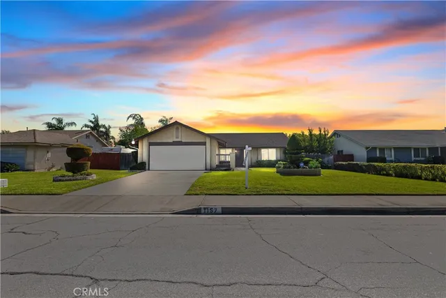 a view of green field with house in background