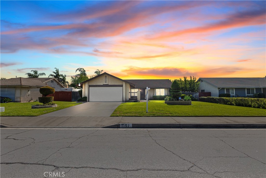 a view of green field with house in background