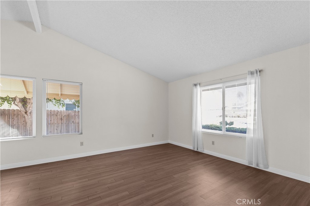 1157 West Orchard Street Rialto, CA 92376 - Photo 11 of 38 an empty room with wooden floor and windows