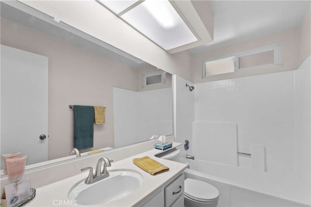 1157 West Orchard Street Rialto, CA 92376 - Photo 20 of 38 a bathroom with a sink toilet vanity and shower