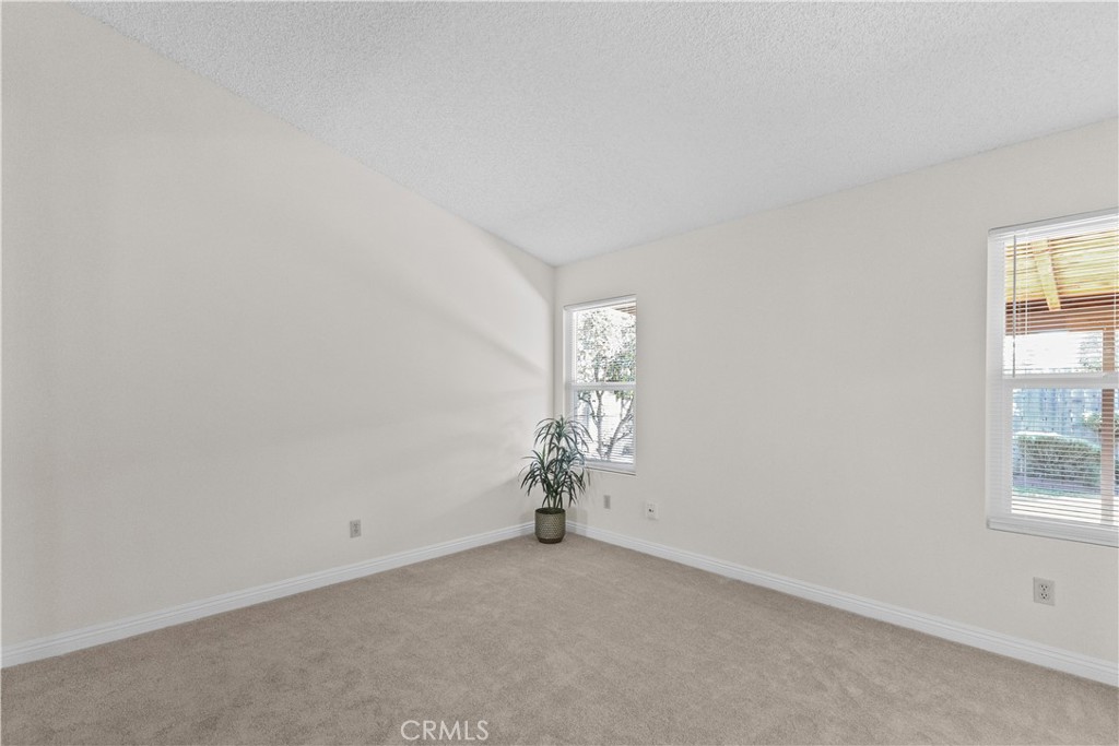 1157 West Orchard Street Rialto, CA 92376 - Photo 23 of 38 an empty room with windows