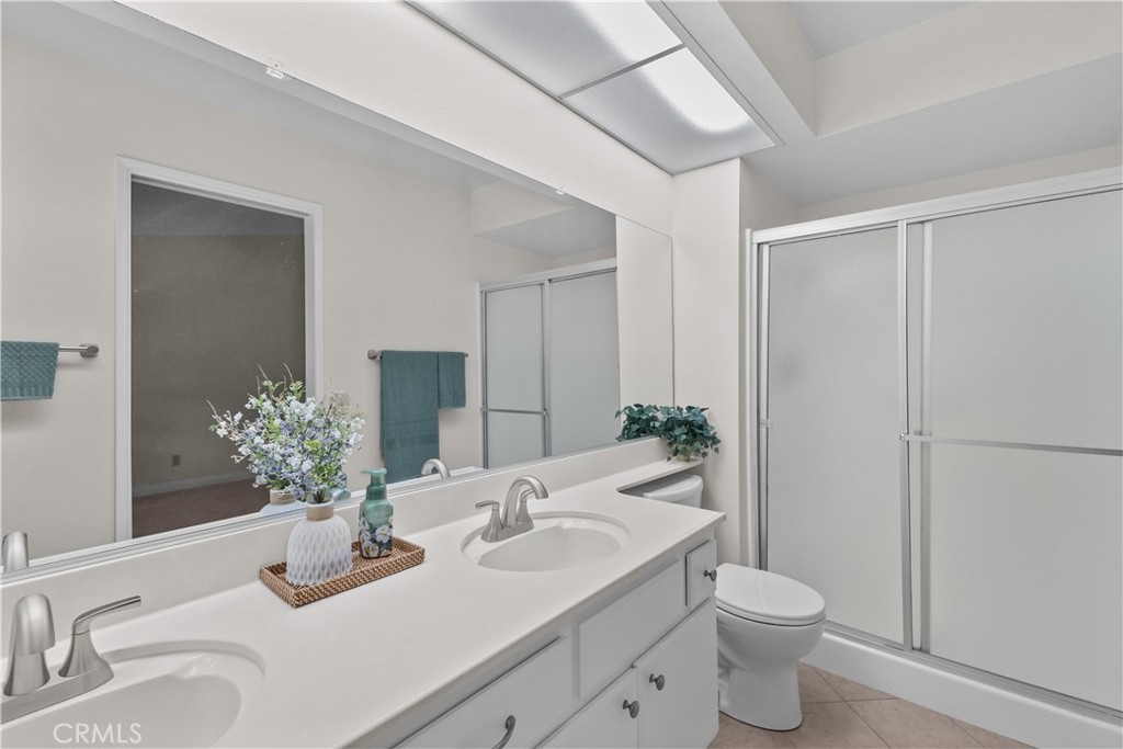 1157 West Orchard Street Rialto, CA 92376 - Photo 25 of 38 a bathroom with a granite countertop sink and a mirror with toilet