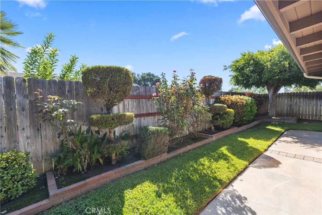 1157 West Orchard Street Rialto, CA 92376 - Photo 36 of 38 a view of a garden with a wooden fence
