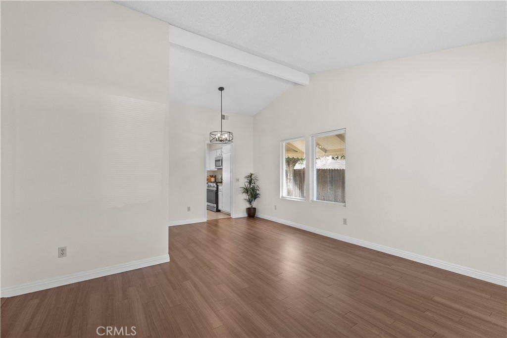 1157 West Orchard Street Rialto, CA 92376 - Photo 5 of 38 a view of an empty room with wooden floor and a window