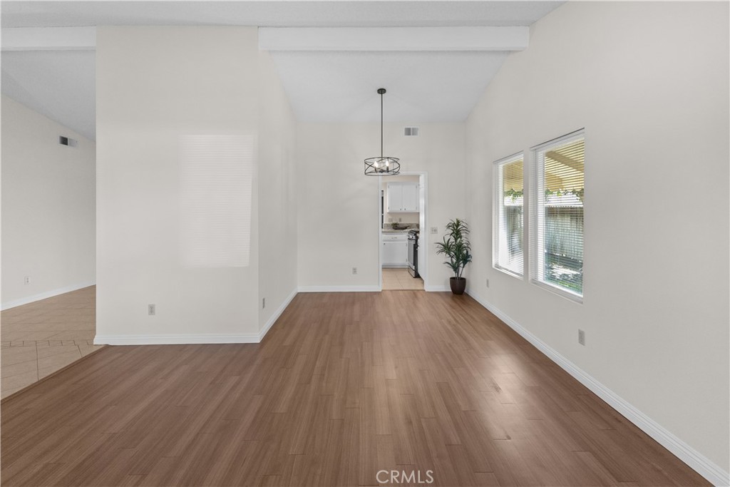 1157 West Orchard Street Rialto, CA 92376 - Photo 6 of 38 an empty room with wooden floor and windows