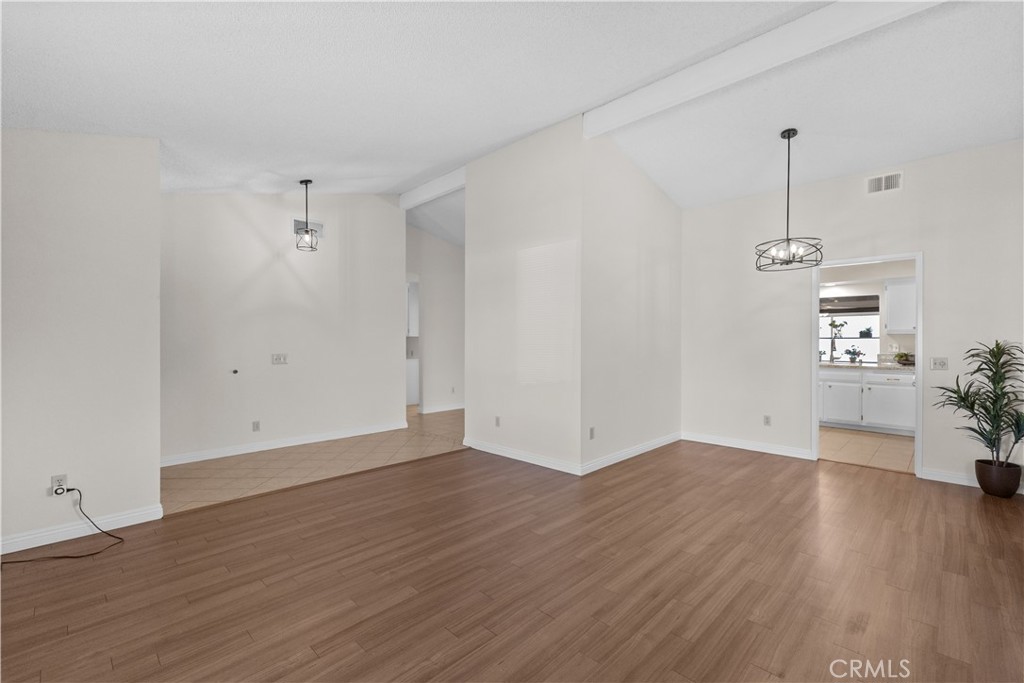 1157 West Orchard Street Rialto, CA 92376 - Photo 7 of 38 an empty room with wooden floor and windows