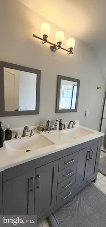 a bathroom with a double vanity sink and mirror