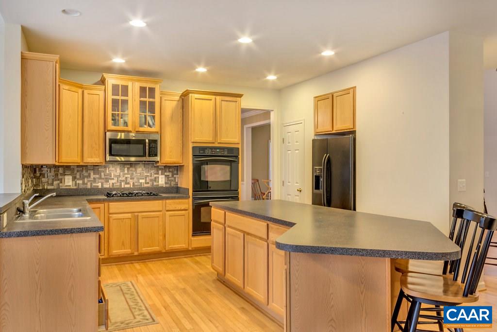 437 Willow Ridge Road Troy, VA 22974 - Photo 11 of 45 a kitchen with stainless steel appliances granite countertop a sink stove and refrigerator