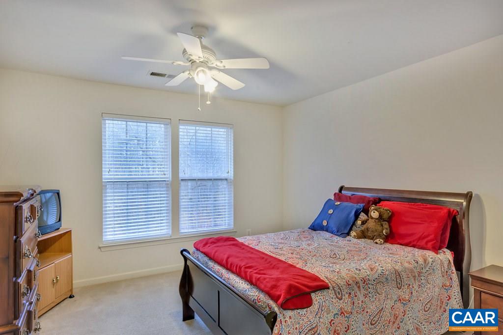 437 Willow Ridge Road Troy, VA 22974 - Photo 23 of 45 a bedroom with a bed and a chandelier