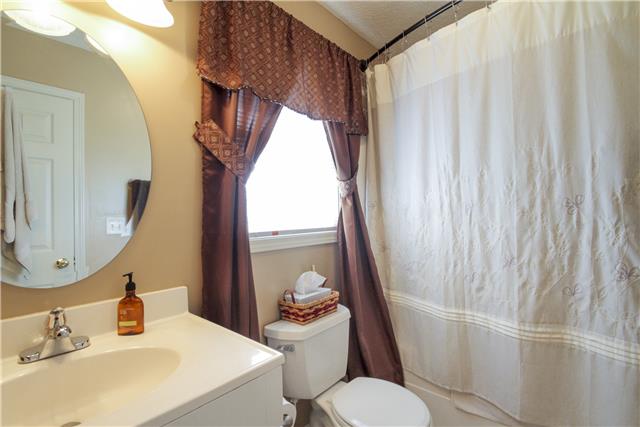 3612 Mahlon Moore Road Spring Hill, TN 37174 - Photo 14 of 20 a bathroom with a sink toilet and mirror