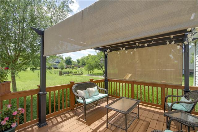 3612 Mahlon Moore Road Spring Hill, TN 37174 - Photo 18 of 20 a balcony with wooden floor table and chairs