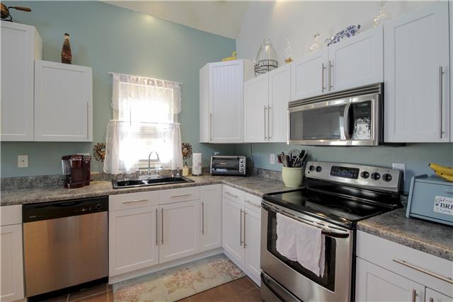 3612 Mahlon Moore Road Spring Hill, TN 37174 - Photo 8 of 20 a kitchen with granite countertop white cabinets sink and stainless steel appliances