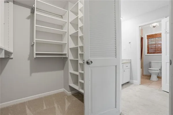 a view of empty room with wooden floor and window