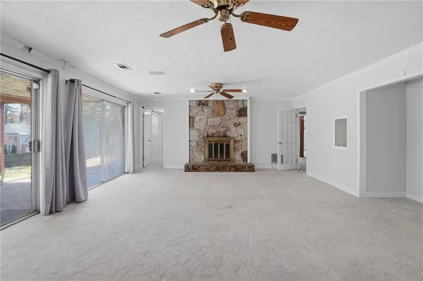 a view of a livingroom with a ceiling fan and window