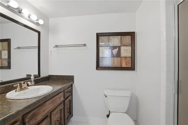 a bathroom with a toilet a sink and mirror