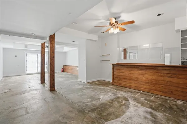 a view of a livingroom with a ceiling fan and window