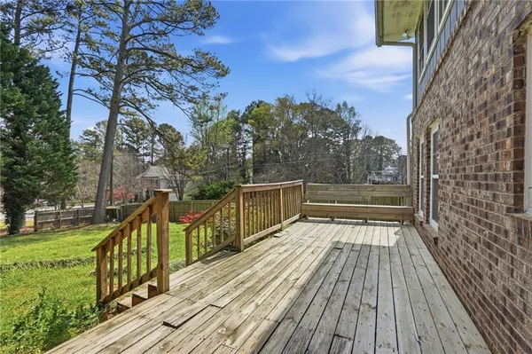 a view of balcony with wooden floor and fence